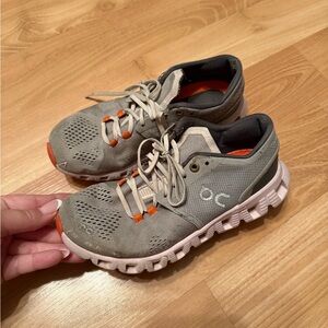 On clouds Gray and Orange tennis shoes
